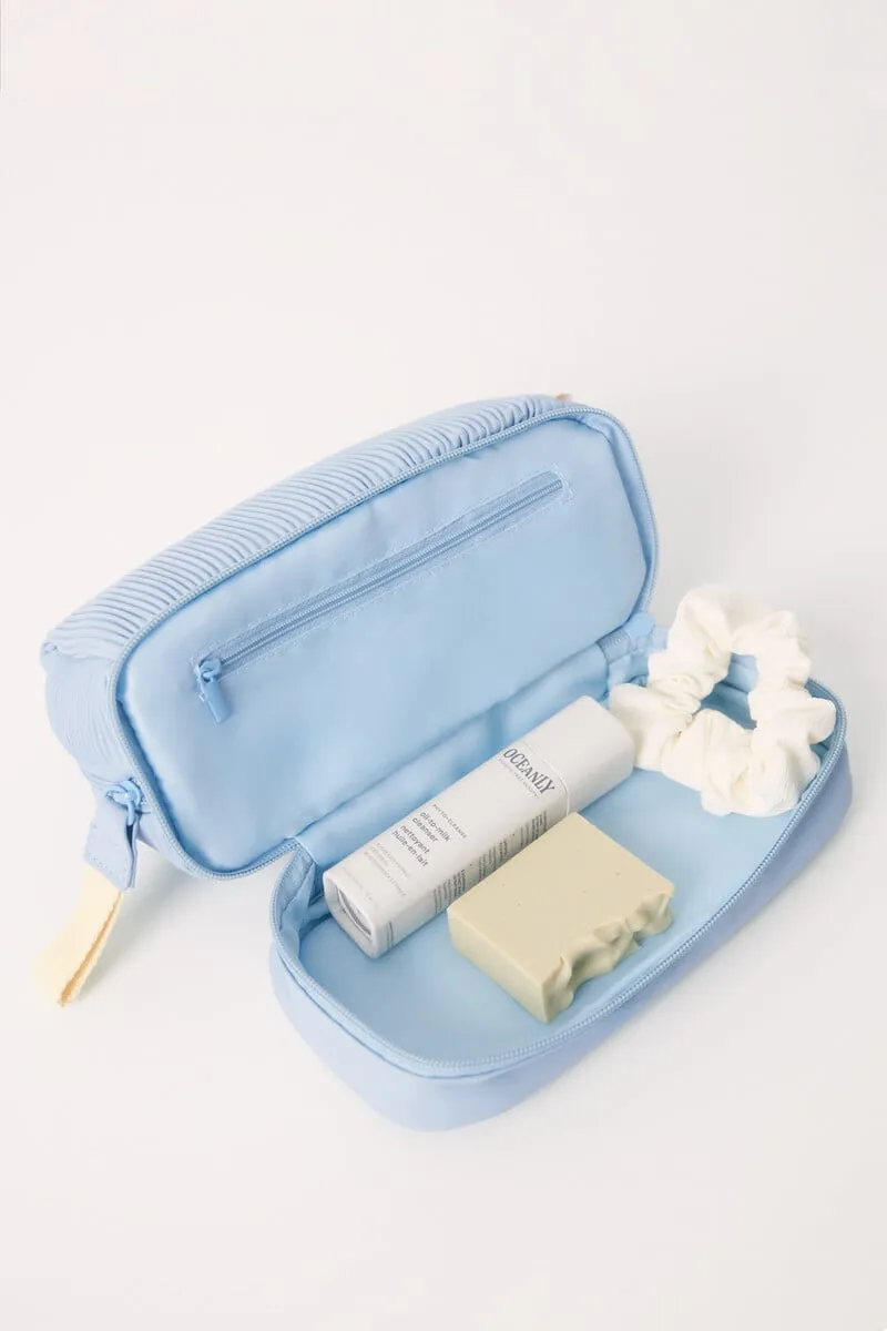 Medium blue rubberized toiletry bag